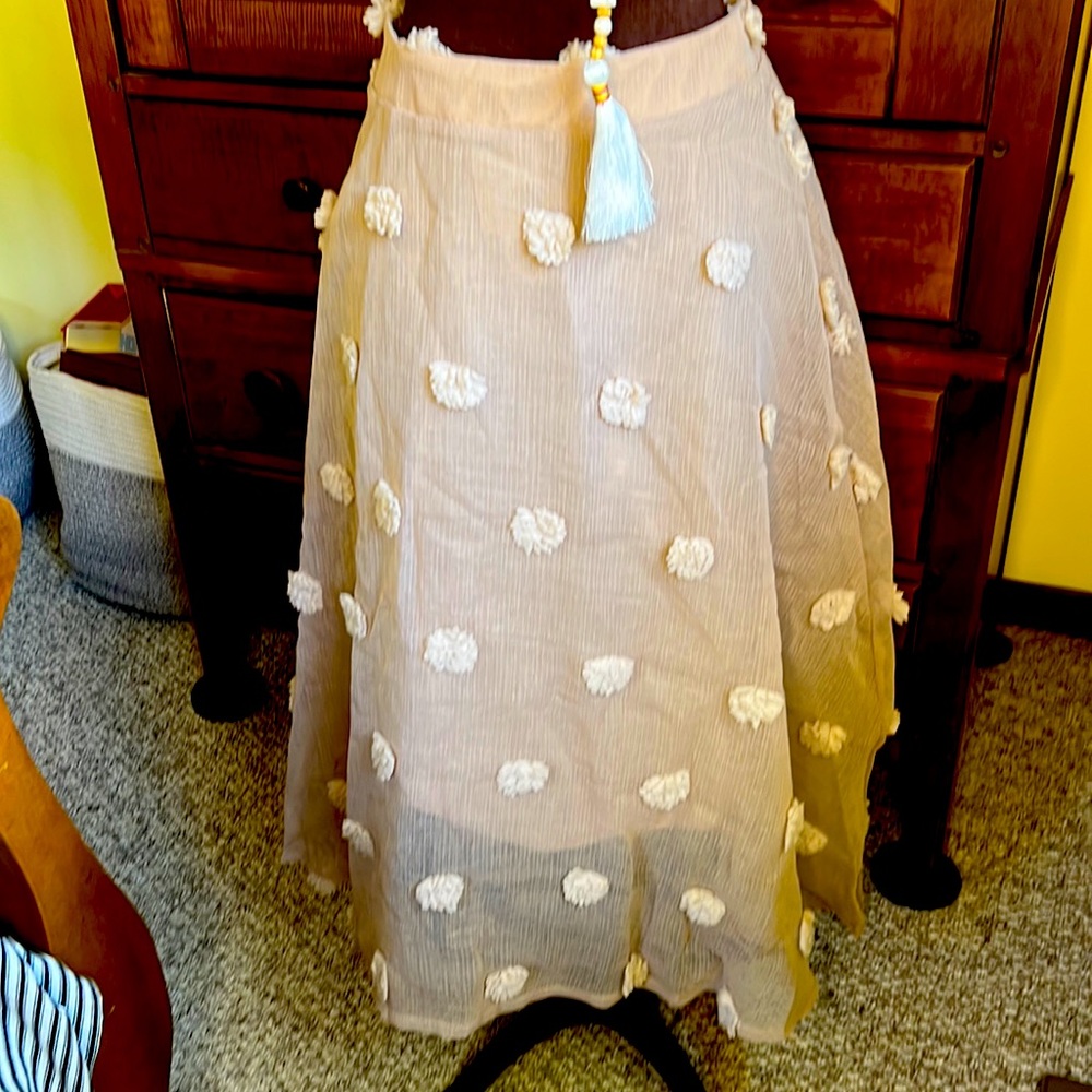 Ladies linen skirt with cream puff balls.